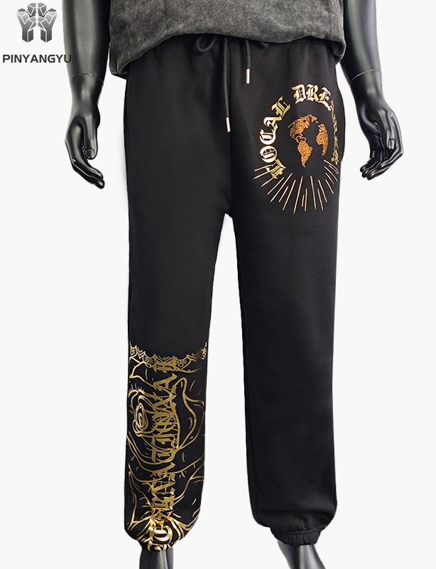 Pantaloni con design in strass e stampa in oro